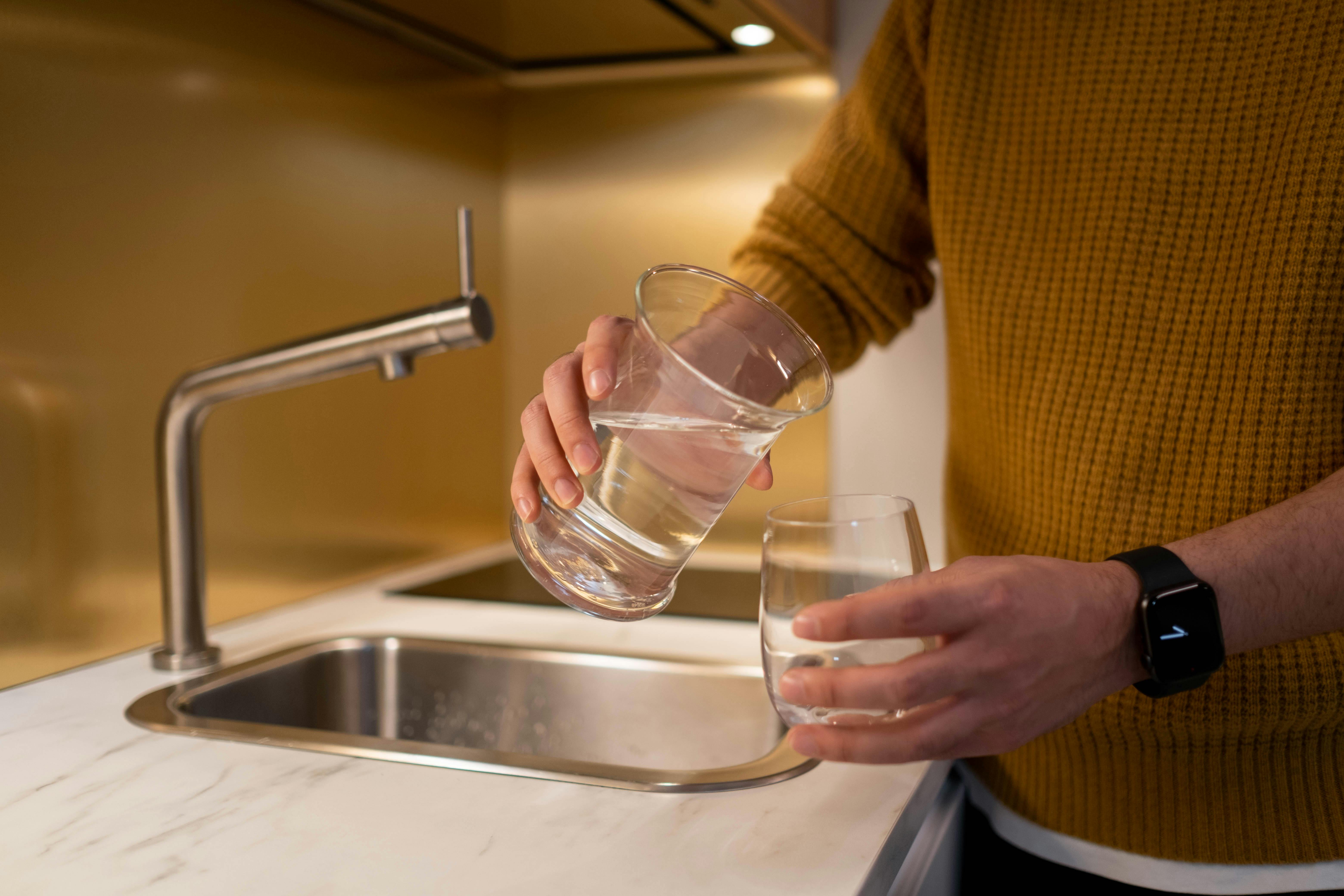 Hand Pouring Water From Glass Pitcher Over White Background Stock Photo,  Picture and Royalty Free Image. Image 46125267.