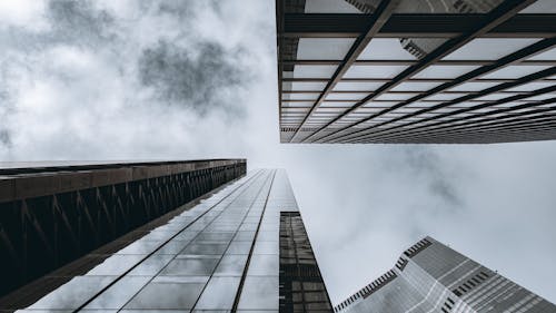 Low Angle Photography of High Rise Buildings Under Cloudy Sky