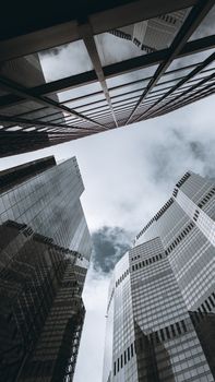 Low angle view of London skyscrapers with reflective glass, showcasing modern architecture.