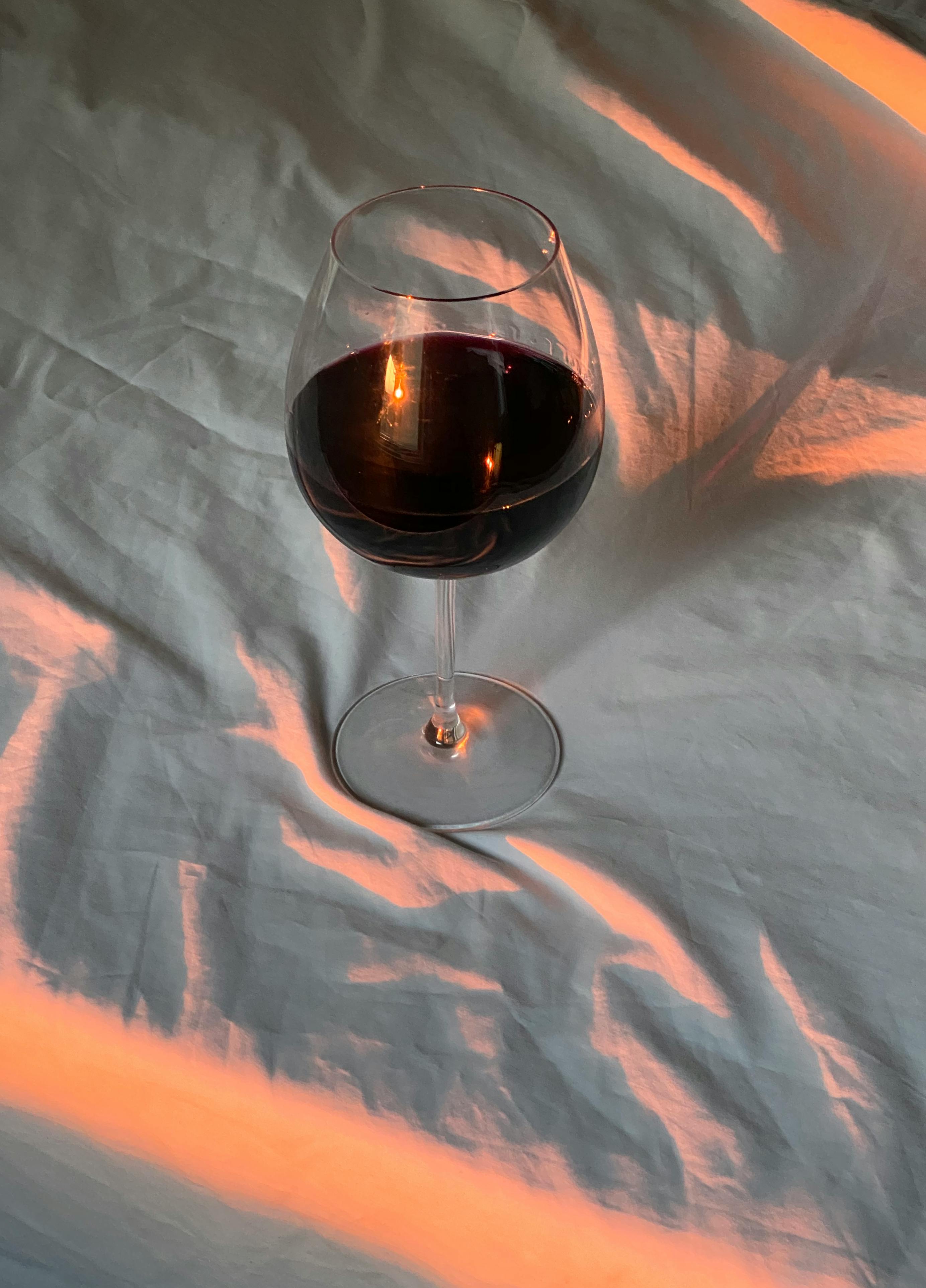 glass of wine on white cloth