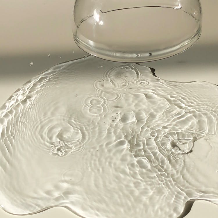 Free Inverted wineglass near spilled water Stock Photo