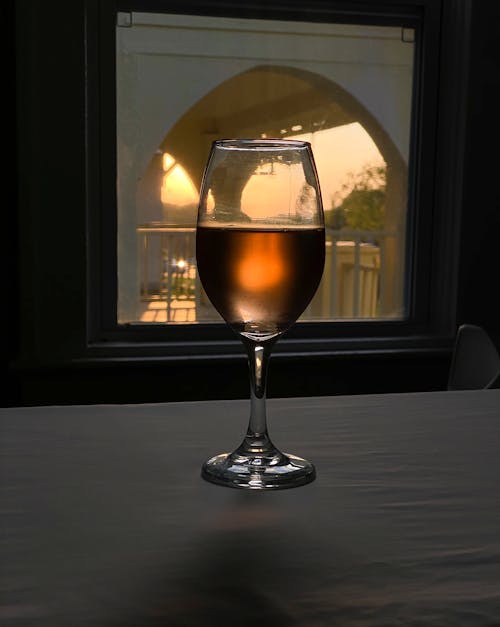 Wineglass on table near window