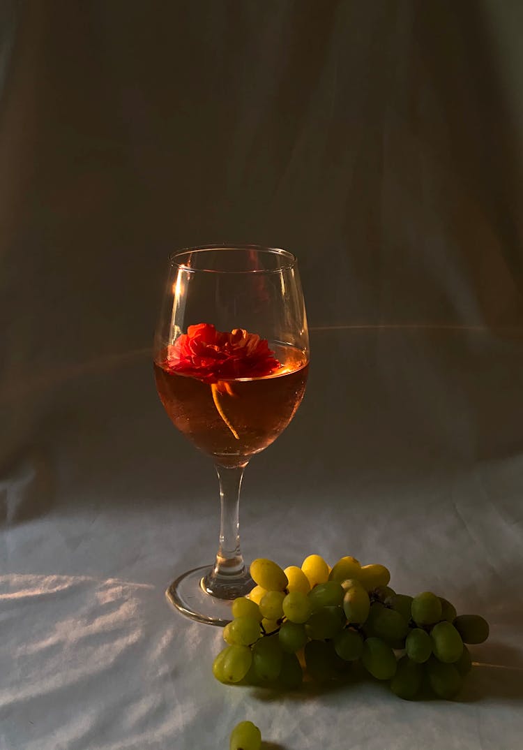 Wineglass Near Ripe Grapes On Textile