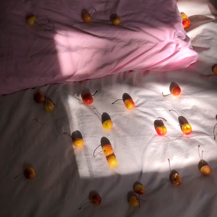 Delicious Cherries Scattered On Soft Bed