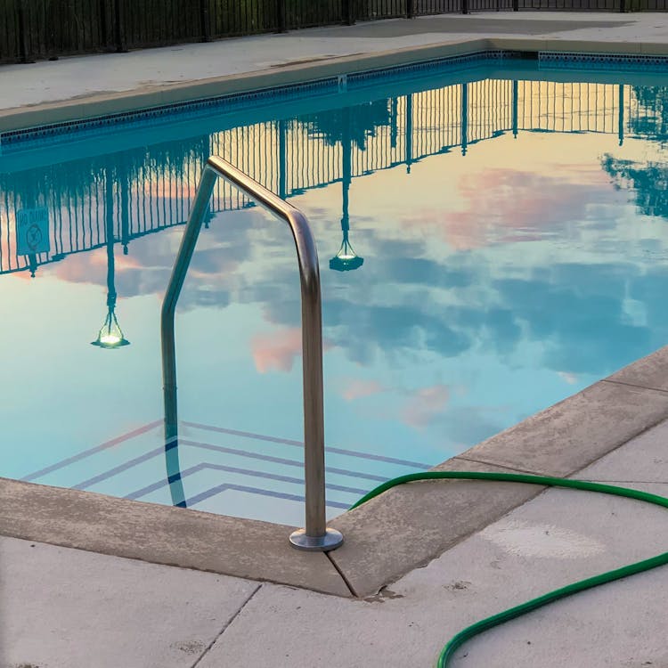 Outdoors Swimming Pool Reflecting Clear Blue Sky