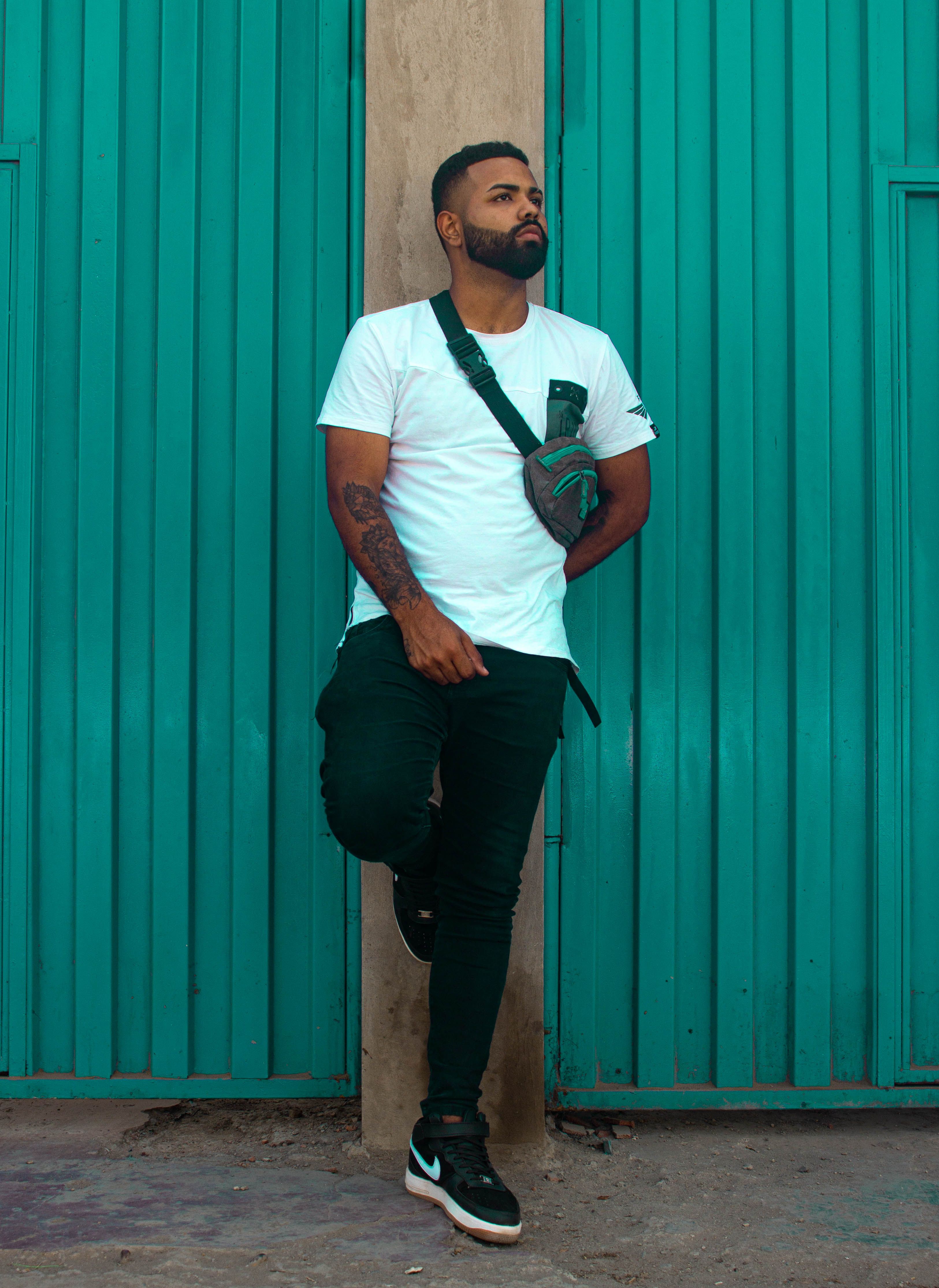 A man wearing a low-profile sling bag across his body