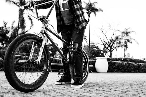 Monochrome Photo of a Person Riding a Bmx Bicycle