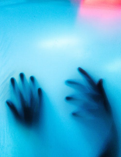 Hands Behind a Blue Translucent Object