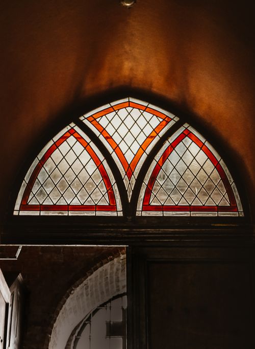Free A striking stained glass window in Pelplin Cathedral, Poland, captures light beautifully. Stock Photo