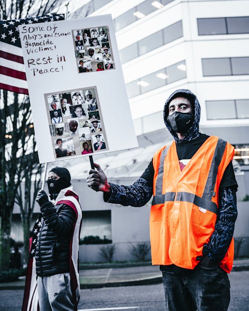 Multiethnic people with banners protesting against genocide