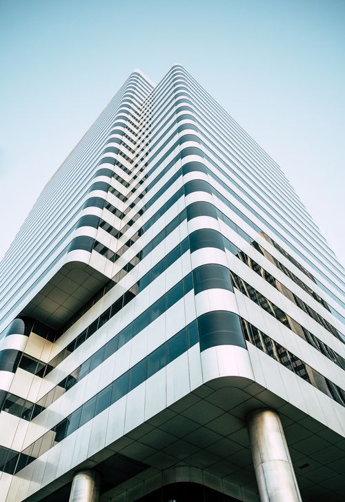 Free From below of contemporary multistory high building with striped black and white facade walls Stock Photo
