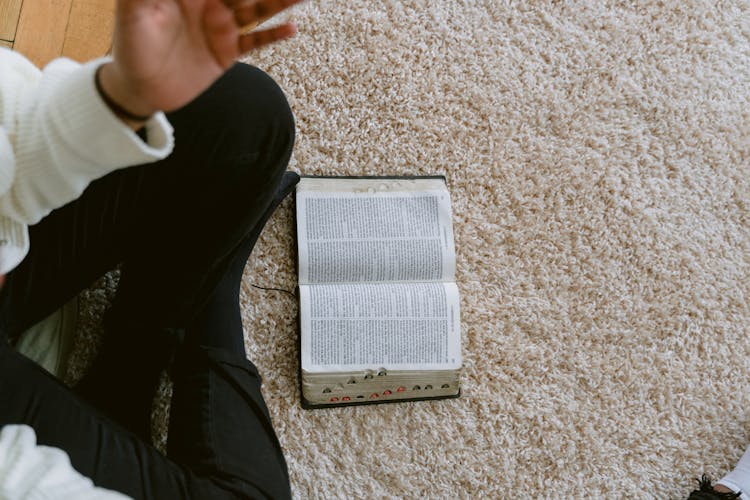 Opened Book On Fur Carpet