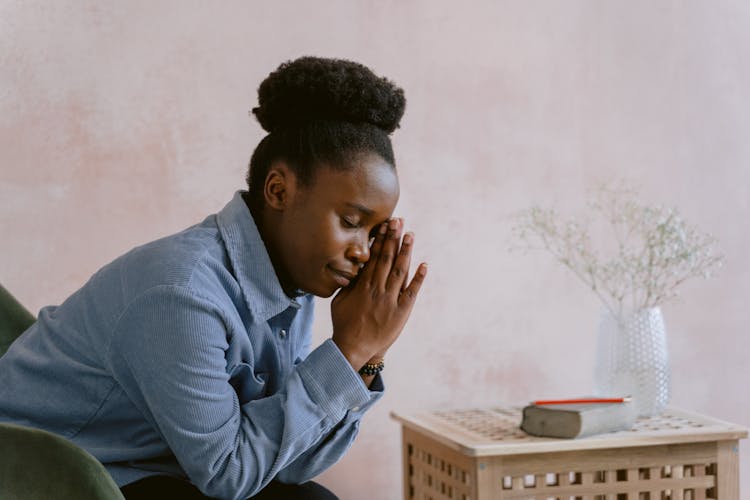 Woman In Blue Dress Shirt Praying