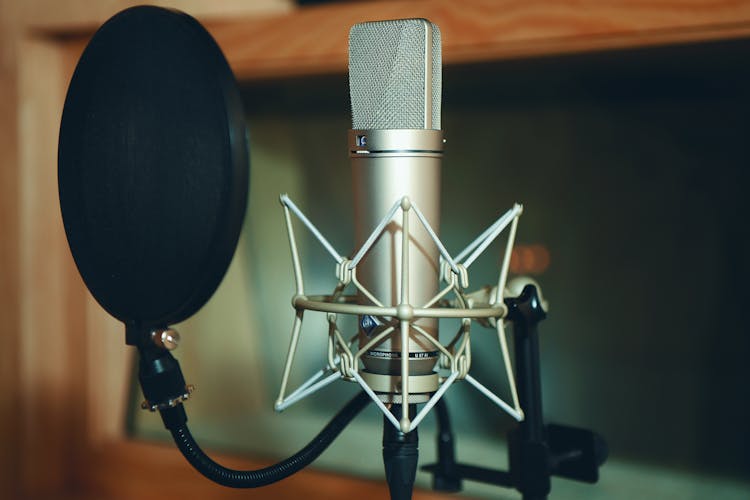 A Close-Up Shot Of A Microphone And A Pop Filter