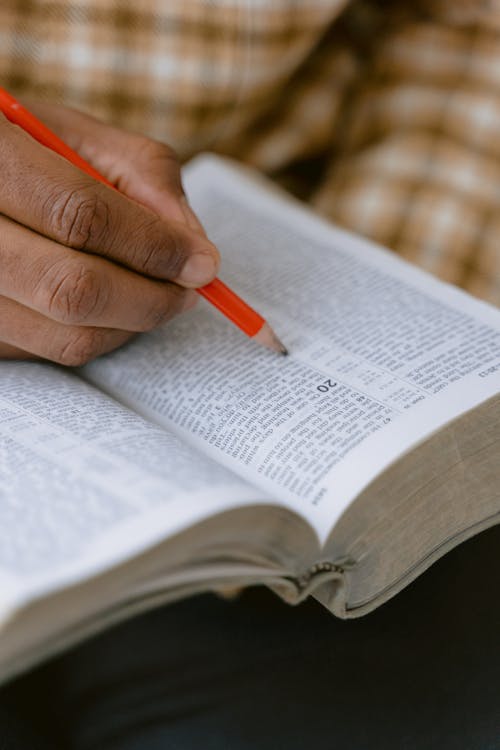 Person Writing on White Paper