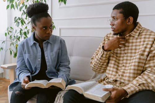 A Man and a Woman Holding a Book