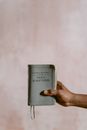 Person Holding Holy Bible