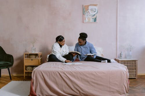 Women Sitting on a Bed