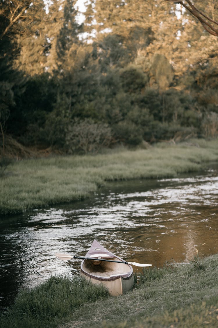 A Canoe On A River Bank