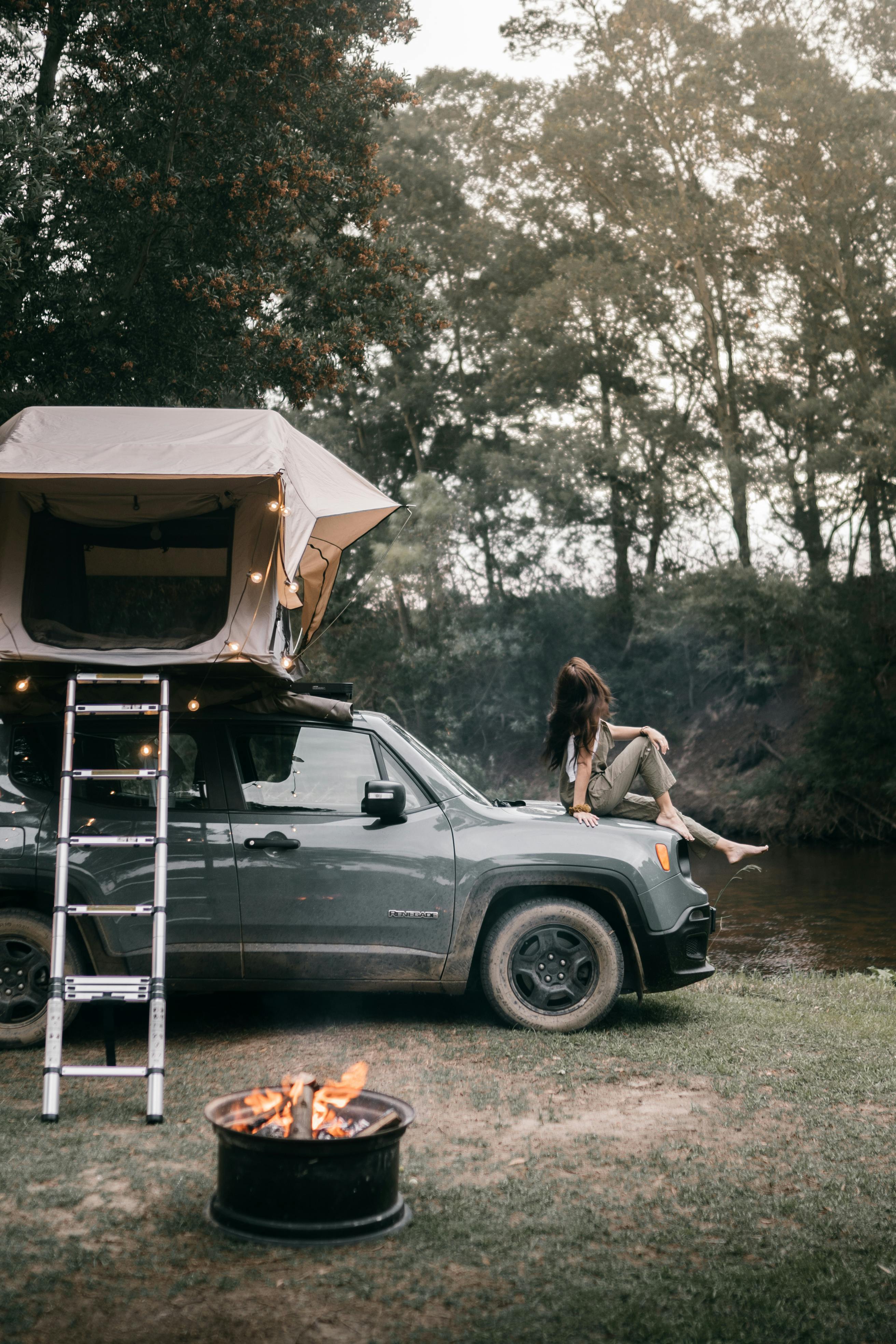 woman sitting on the hood of a car