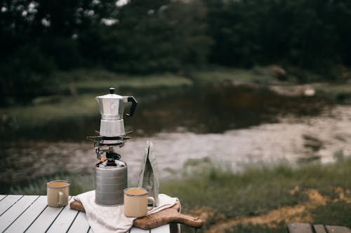 A Moka Pot Near Mugs