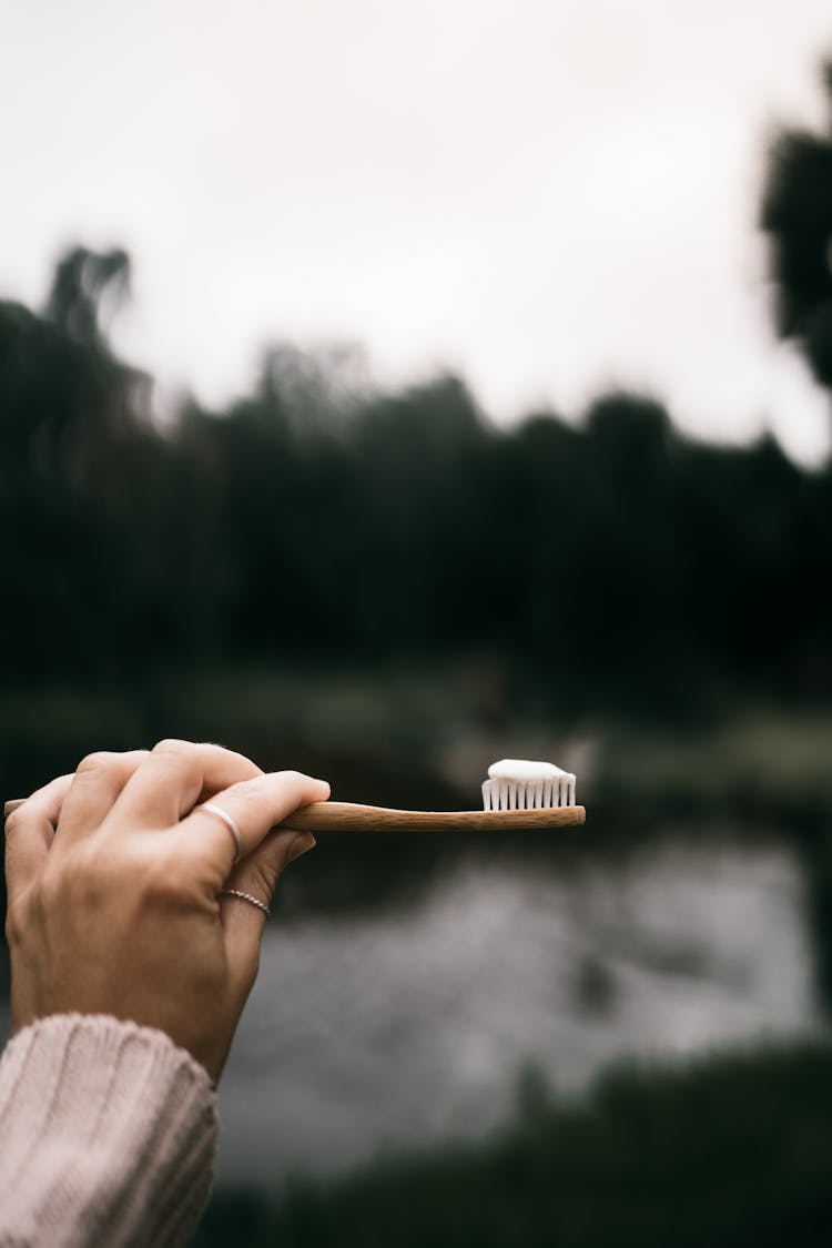 A Person Holding A Toothbrush