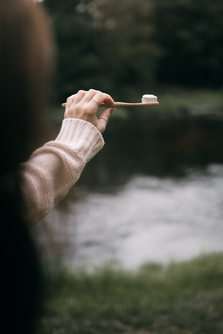 A Woman Holding A Toothbrush