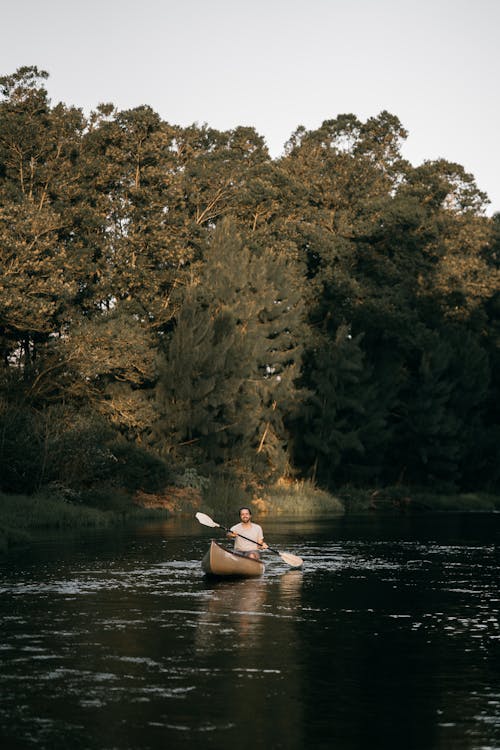 Free A Man Kayaking on a Lake Stock Photo