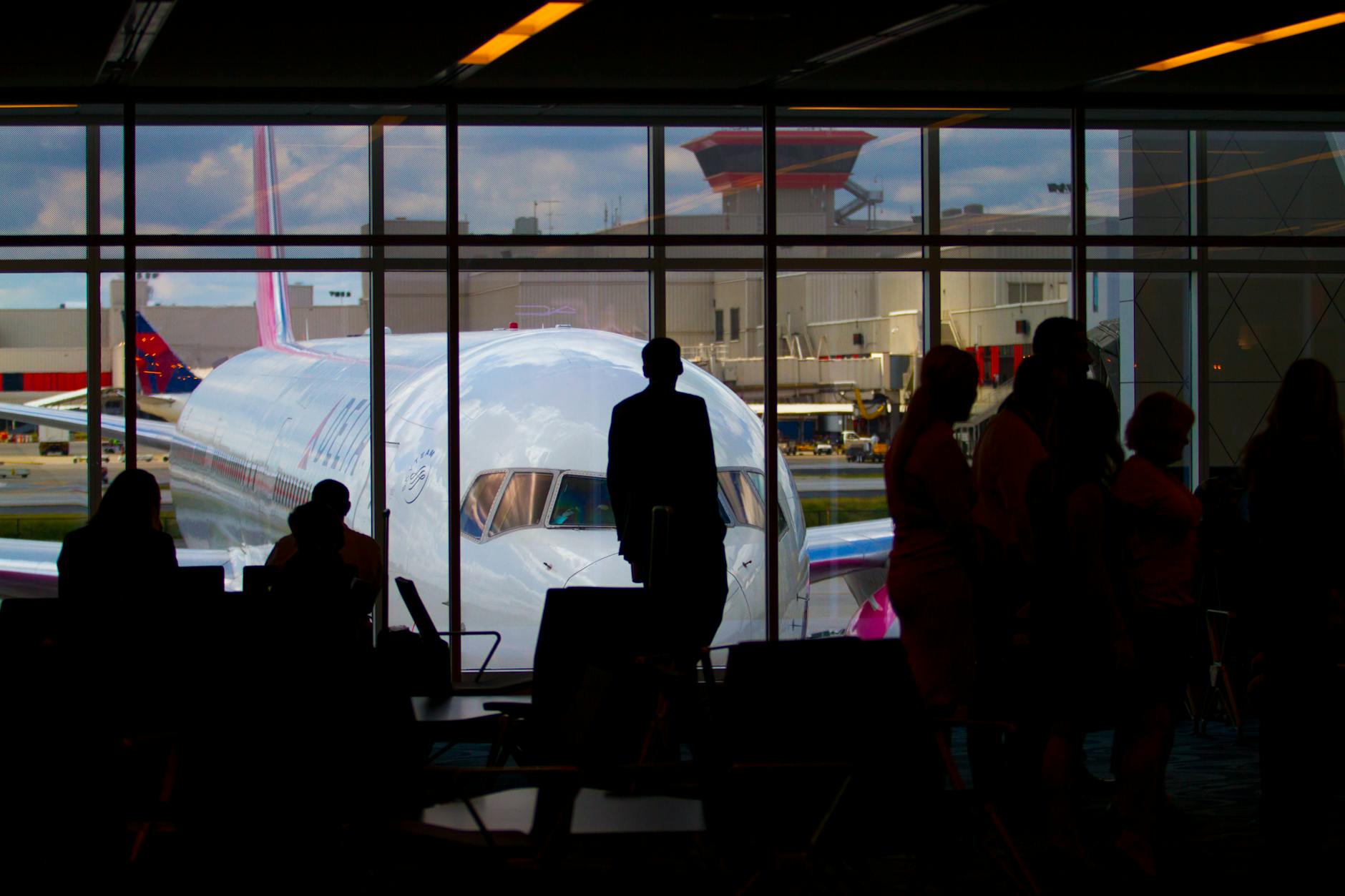 Passengers waiting in crowded LaGuardia Airport terminal during flight delays