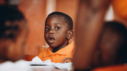 A Boy Wearing an Orange Polo Shirt