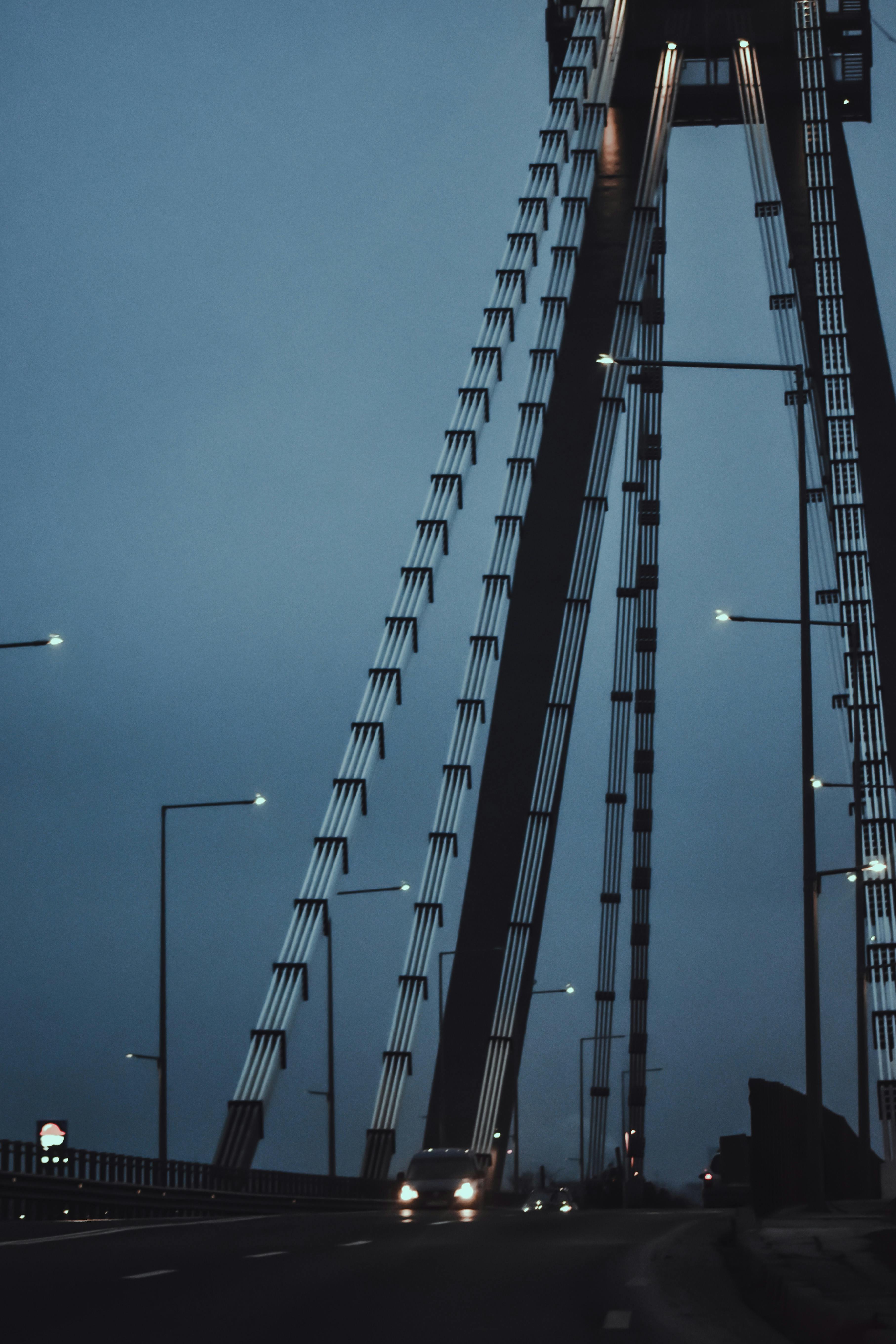 cars driving on bridge in twilight