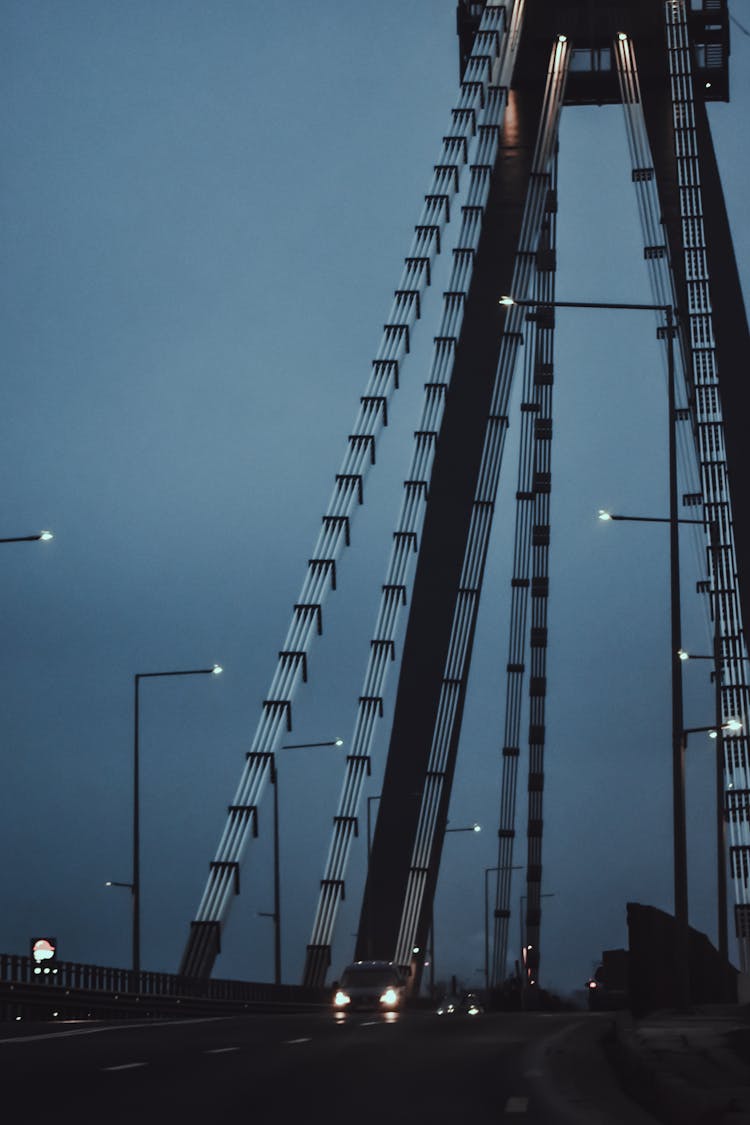 Cars Driving On Bridge In Twilight