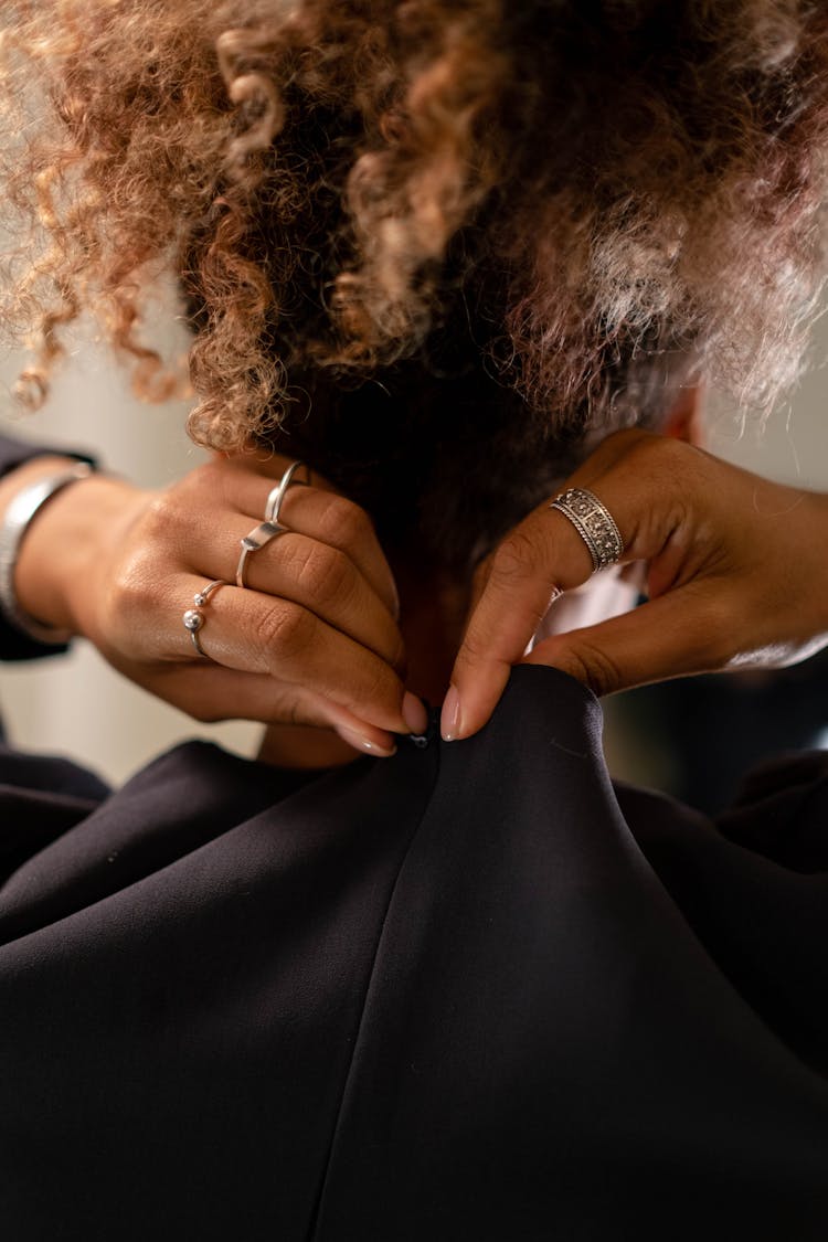 Back View Of A Woman Fastening Her Zipper