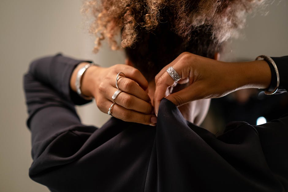 A Woman Zipping Her Black Dress