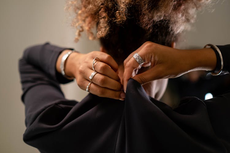 A Woman Zipping Her Black Dress