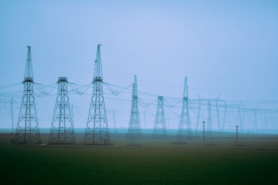 Rows of electricity transmission towers at an industrial power station
