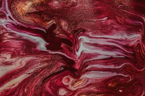 Overhead view of backdrop representing abstract gouache painting with curved brown and pink fluids