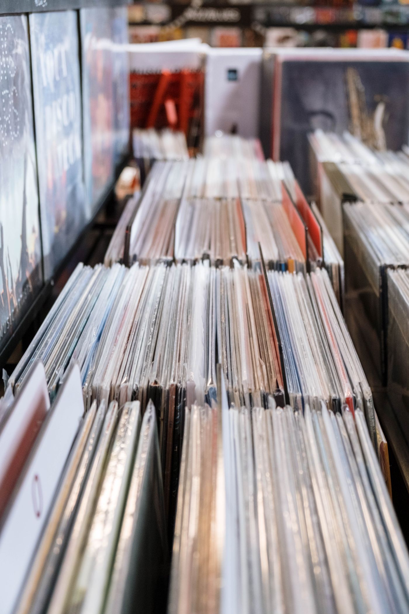 A rack of vinyl record spines in a shop