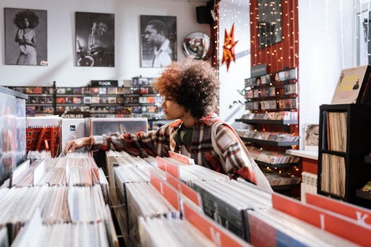 Afro-haired woman browsing vintage vinyl records in a cozy music store.