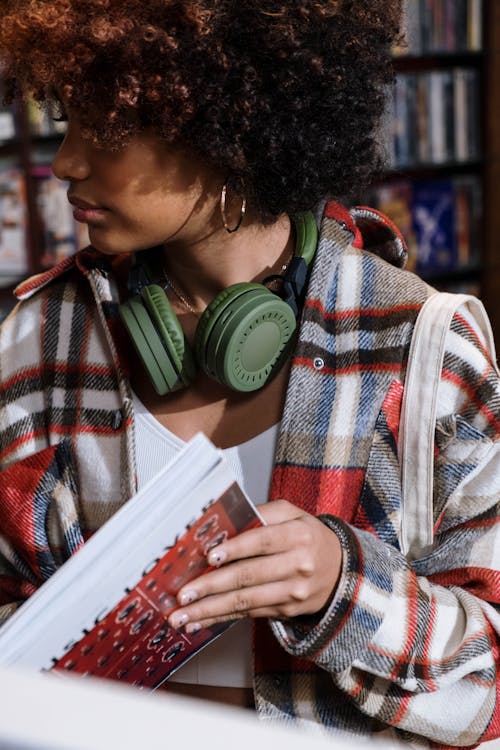 Woman in Red White and Black Plaid Dress Shirt Wearing Headphones
