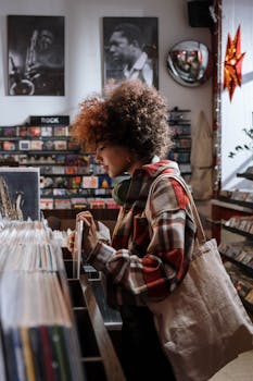 Afro-haired woman shopping for vinyl records in a vintage music shop, enjoying the experience.