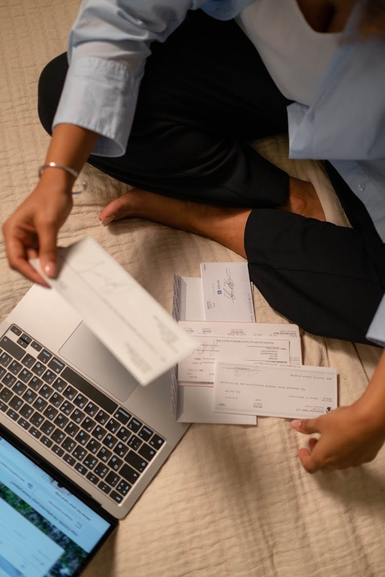 Overhead Shot Of A Person Holding A Cheque