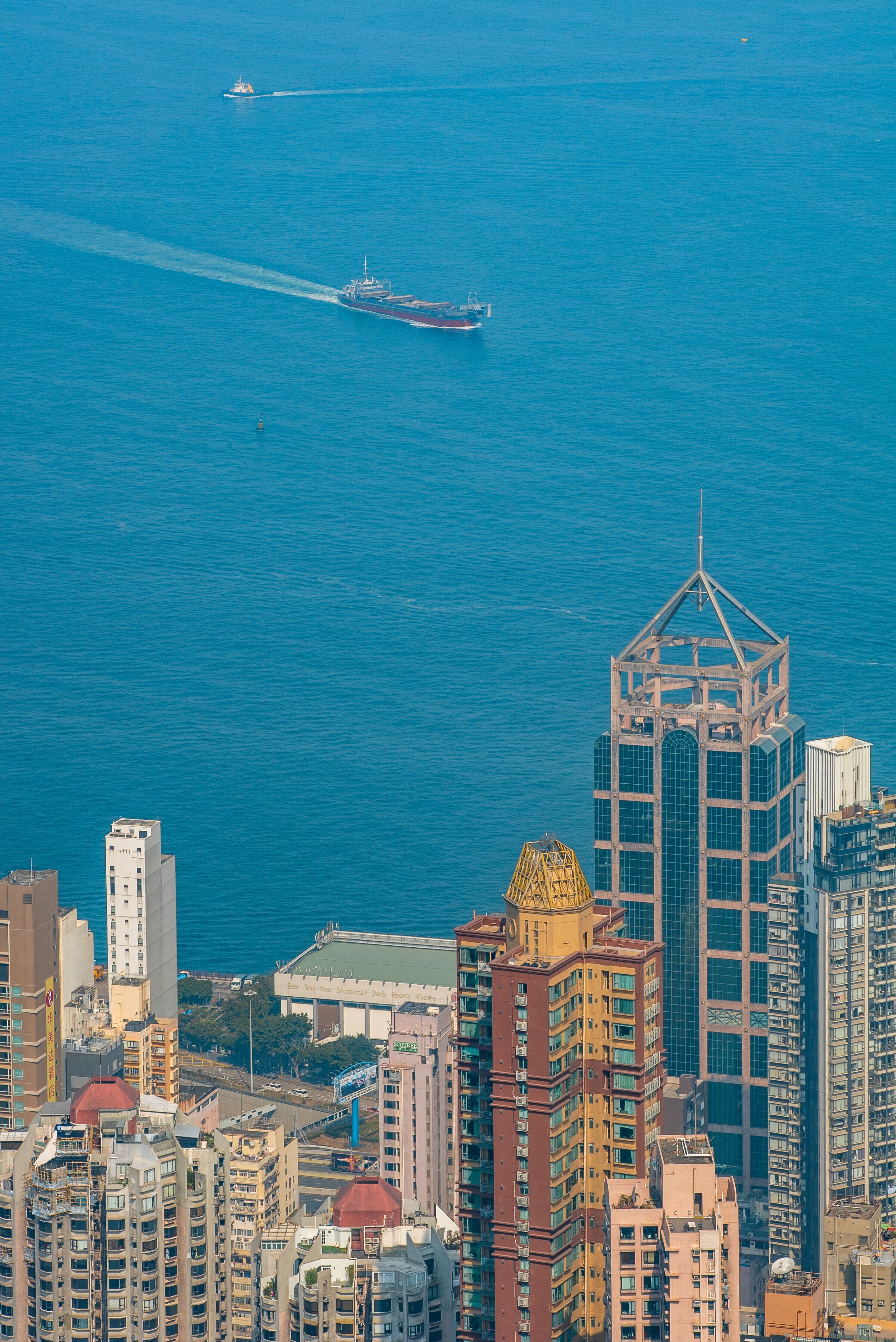 High-Rise Buildings Near a Cargo Ship · Free Stock Photo
