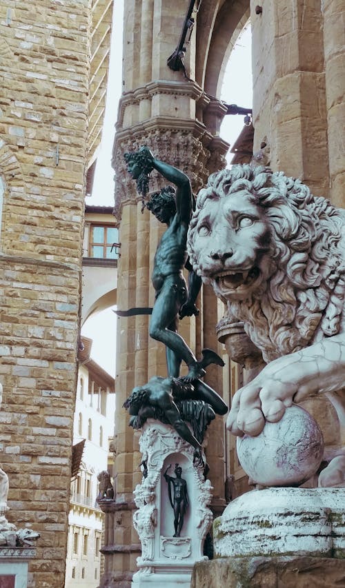 Grey Lion Statue Near Brown Concrete Building