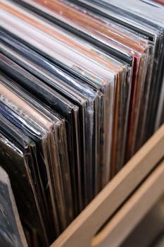 Explore a classic vinyl record collection neatly arranged on a shelf, capturing nostalgia and music history.