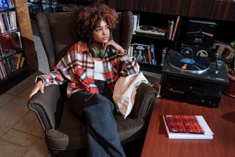 Woman In A Plaid Shirt Sitting Near A Gramophone