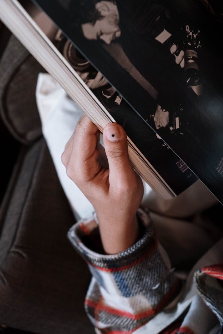 A Person Holding A Magazine