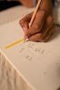 Close-Up Shot of a Person Writing on a Notebook