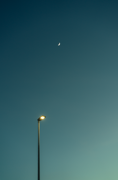 Free Minimalist shot of a street lamp and crescent moon against a serene night sky in Berne, Switzerland. Stock Photo