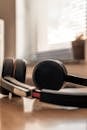 Black and Gray Headphones on Brown Wooden Table